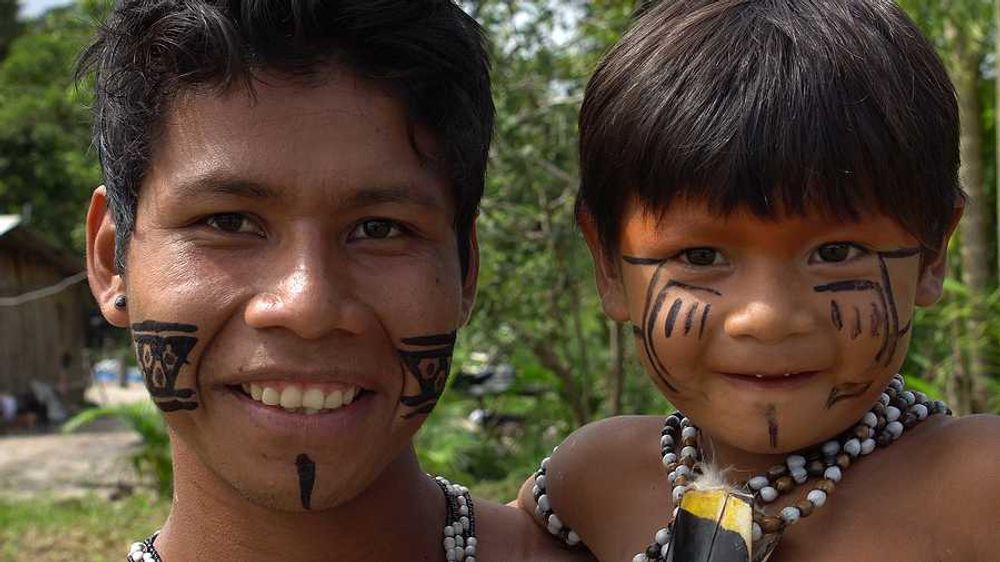 An indigenous man and his child in the jungle
