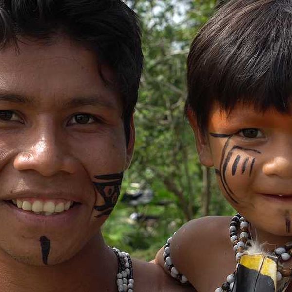 An indigenous man and his child in the jungle