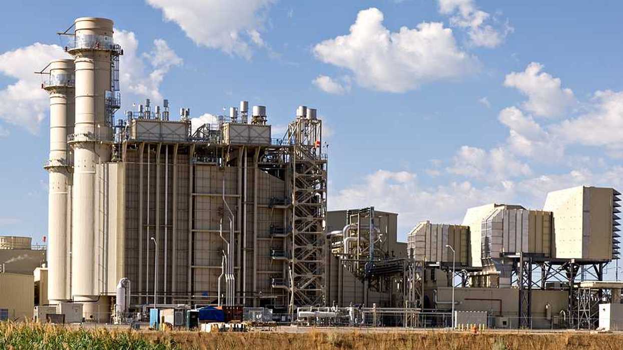 An industrial plant with fields in the foreground