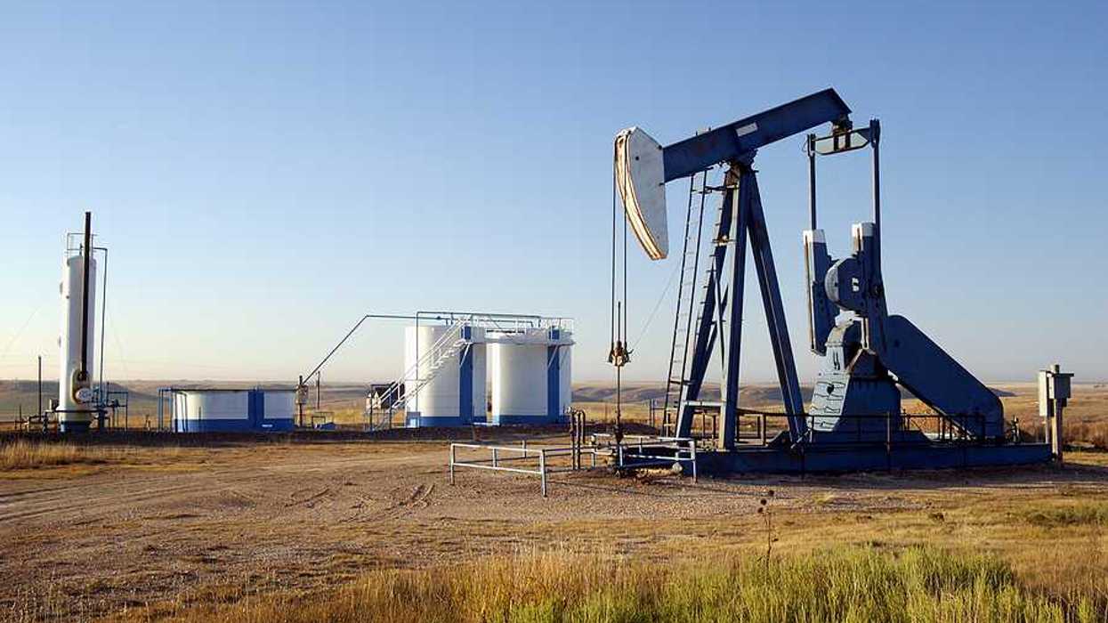 An oil pump jack in the middle of a field