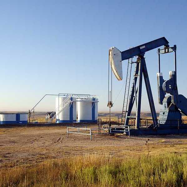 An oil pump jack in the middle of a field