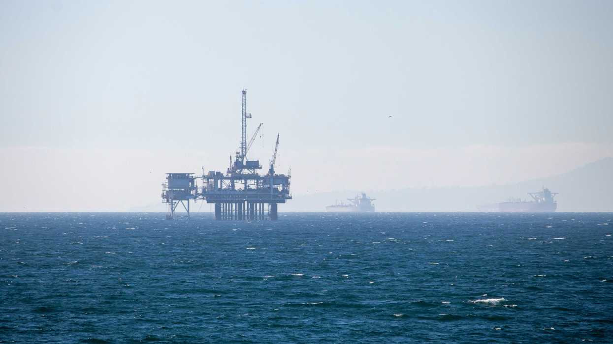 An oil rig in the middle of the ocean.