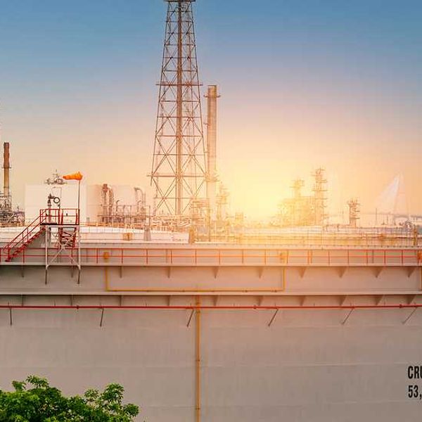 An oil tank with the sunset in the background