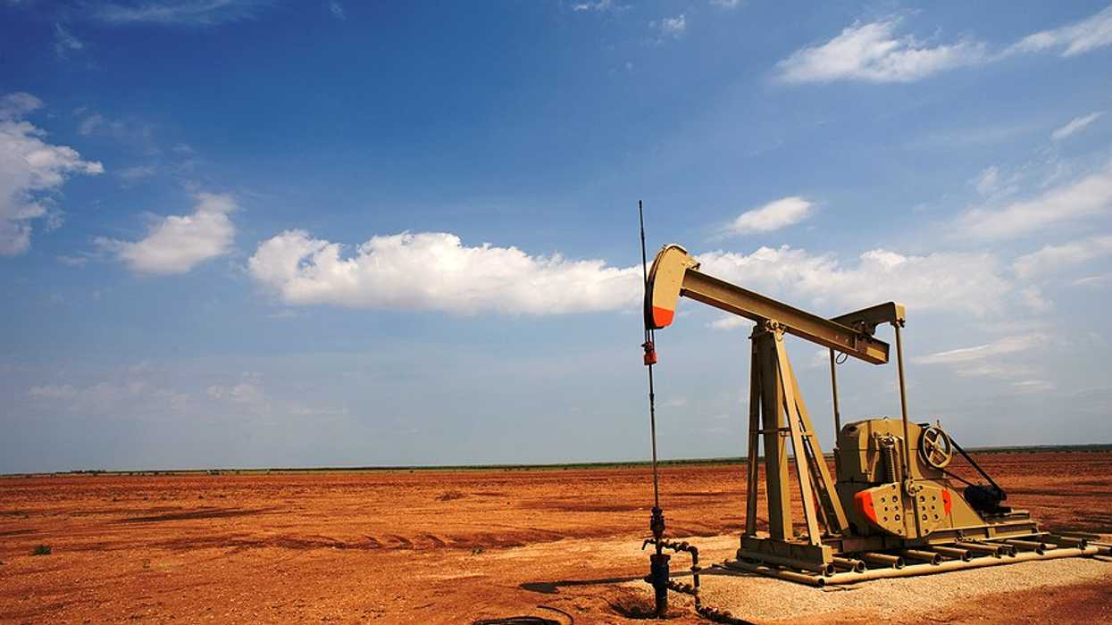 An old oil pump jack in a dry field