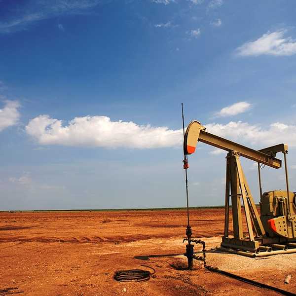 An old oil pump jack in a dry field