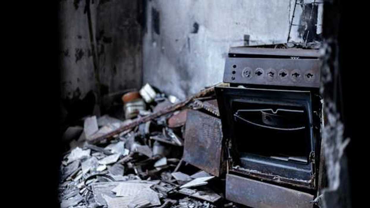 An old oven sitting in the middle of a destroyed building