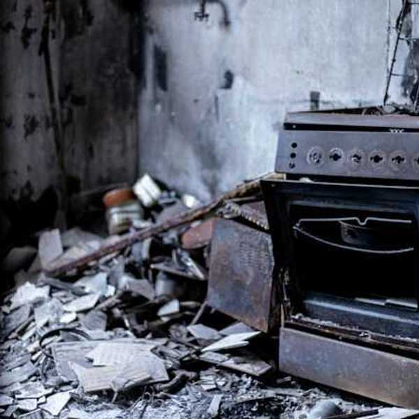 An old oven sitting in the middle of a destroyed building