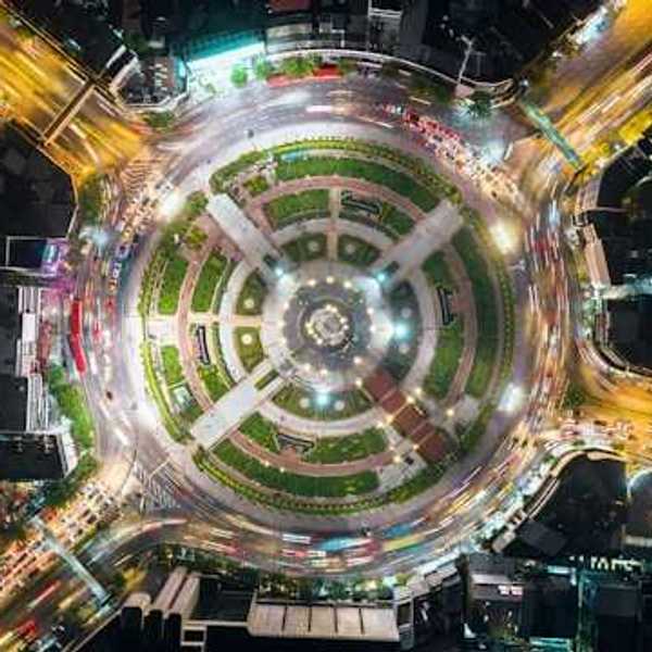 An overhead view of a city roundabout with a park in the middle