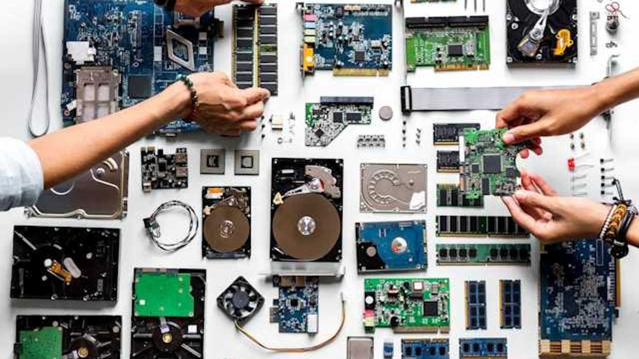 An overhead view of a table covered with electronic waste