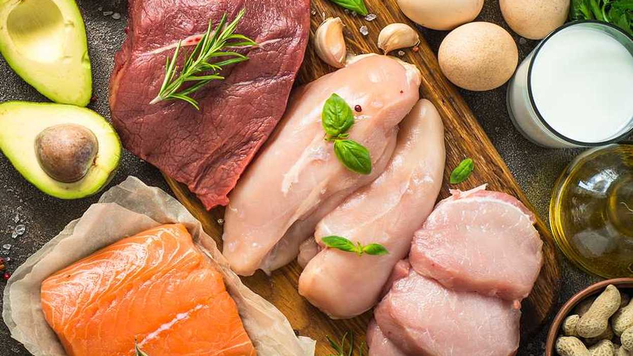 An overhead view of a table filled with meats, fish, poultry, and eggs