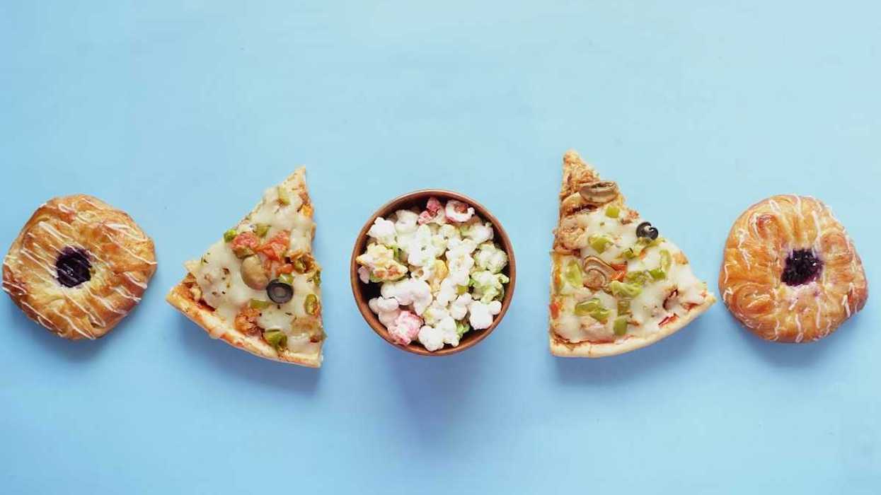 array of unhealthy ultraprocessed foods: pizza, jelly donuts, popcorn
