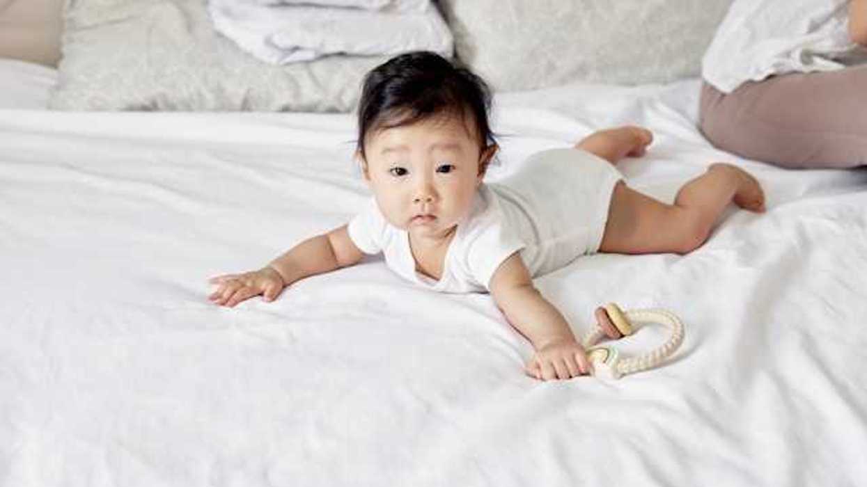 Asian baby on a bed