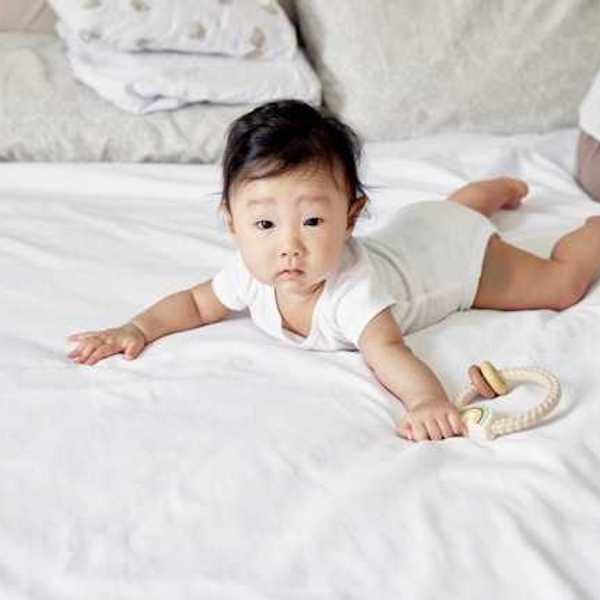 Asian baby on a bed