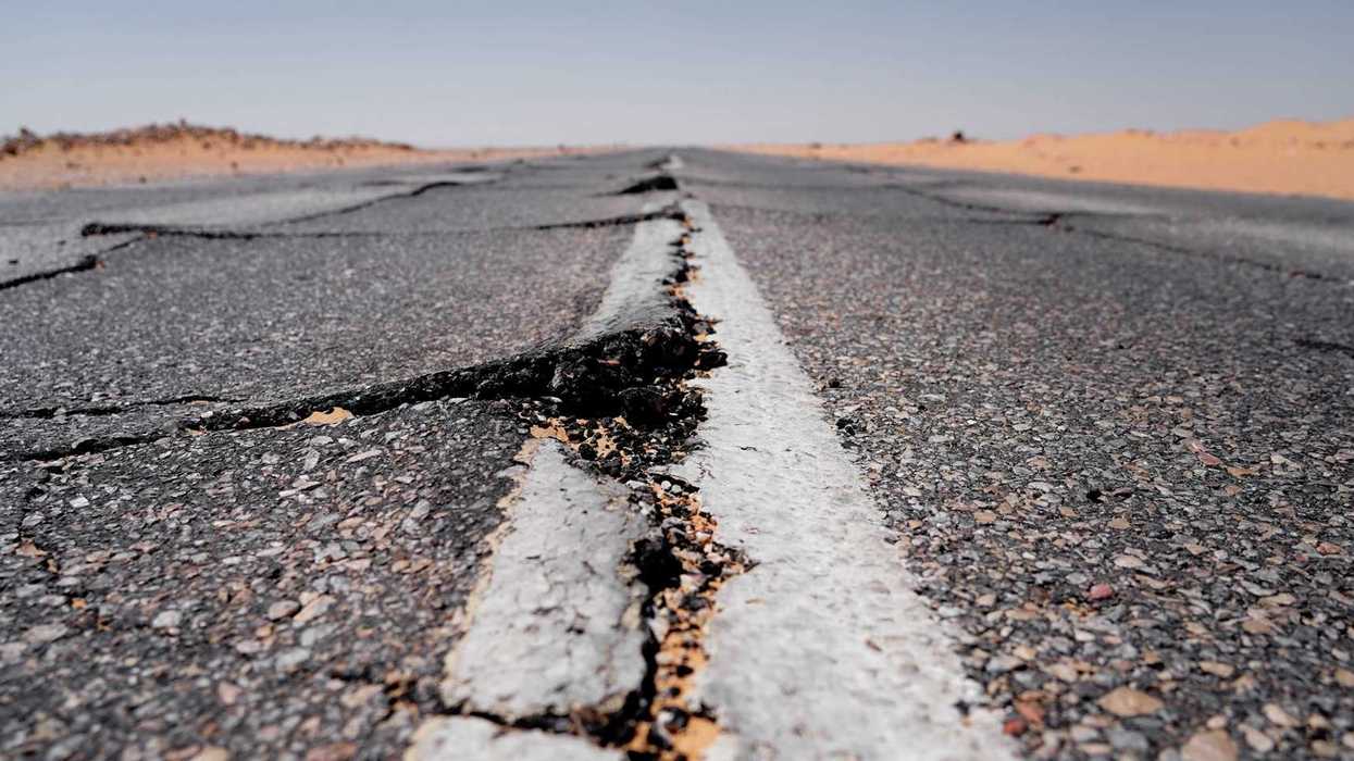 Asphalt roadway showing buckling from extreme heat