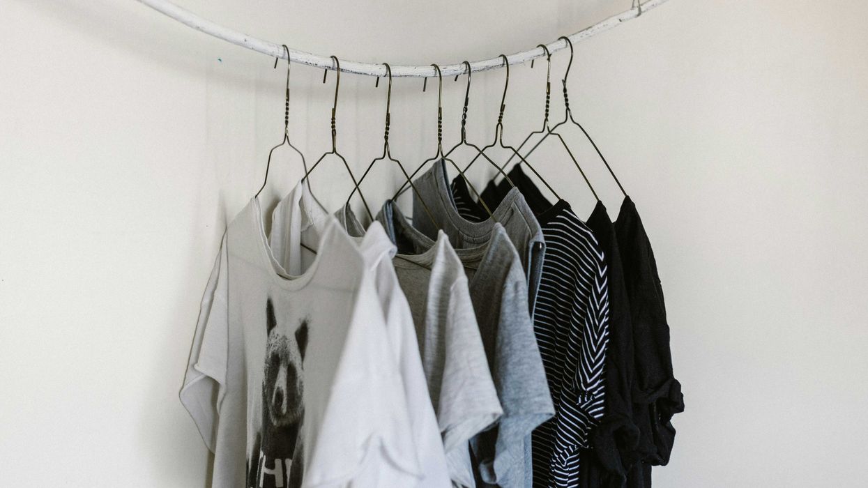 assorted-color clothes hanging on rod.