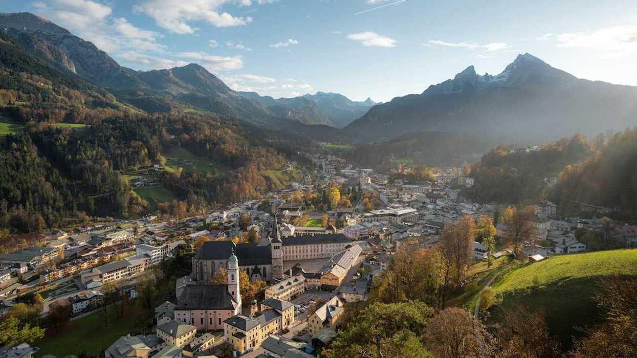 Bavarian town in an alpine valley beneath snow-capped peaks