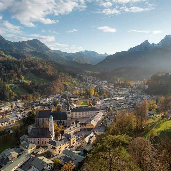 Bavarian town in an alpine valley beneath snow-capped peaks