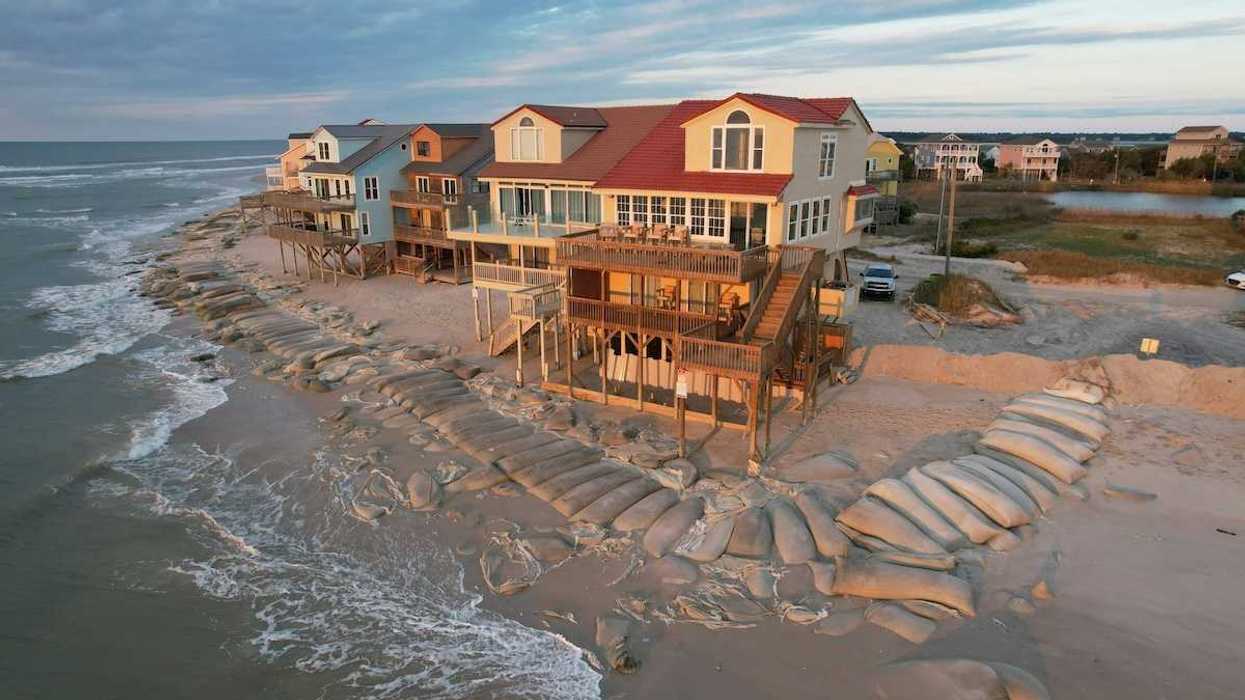 Beach homes, partially protected by sand bags, at the edge of North Topsail Island in North Carolina coast.