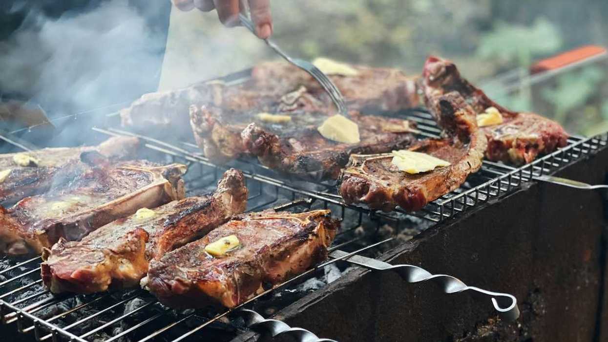 Beef with tabs of butter on an outdoor grill