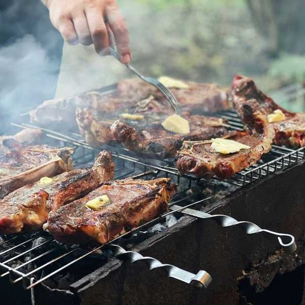 Beef with tabs of butter on an outdoor grill