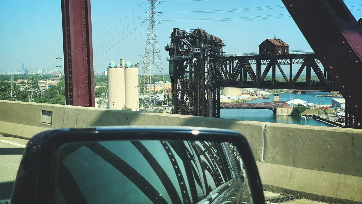 black car near brown metal bridge during daytime