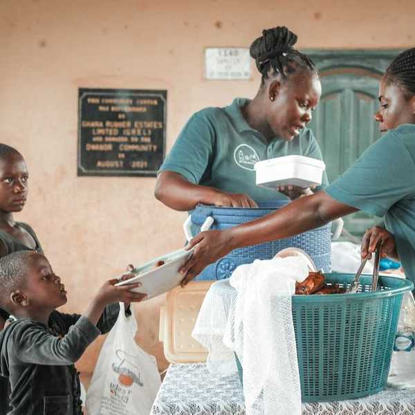 Black children being served at a food kitchen.