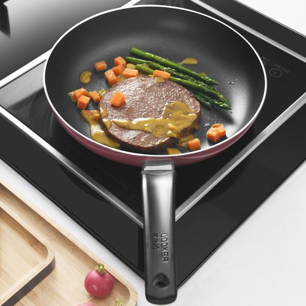black nonstick frying pan with cooked food.