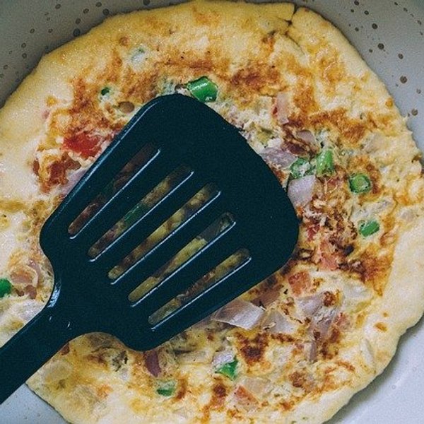 black plastic spatula on an omelet
