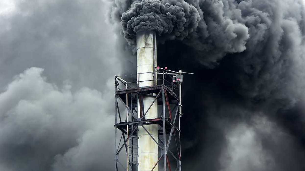 Black smoke billowing out of a smokestack