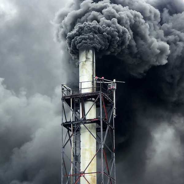 Black smoke billowing out of a smokestack