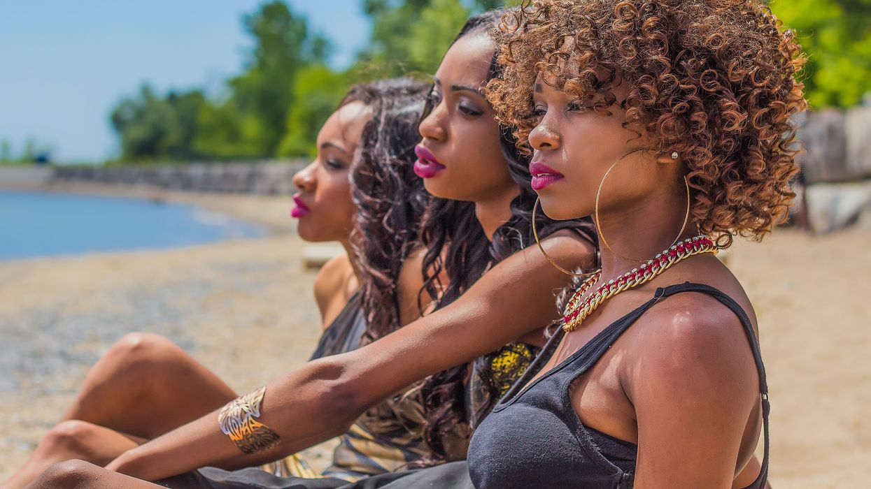 black woman sitting on beach