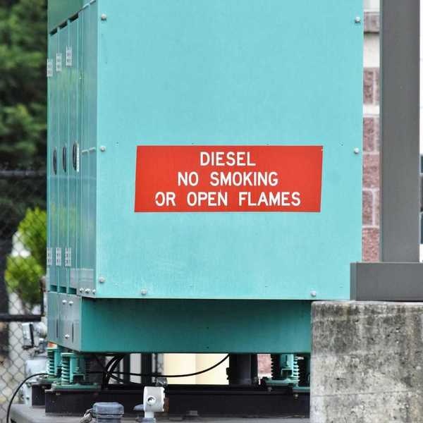 Blue-green diesel generator with signage reading: "DIESEL NO SMOKING OR OPEN FLAMES"