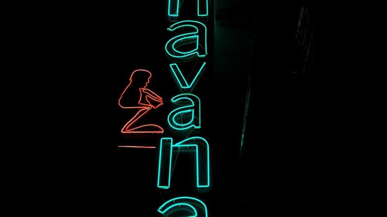 Blue-green neon sign on black background reads "Havana"