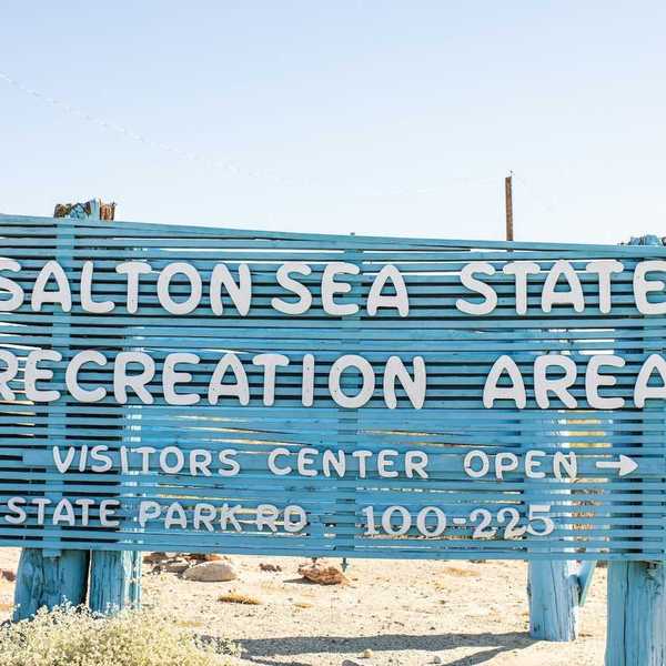 Blue sign with white letters announcing the entrance to Salton Sea Recreation Area