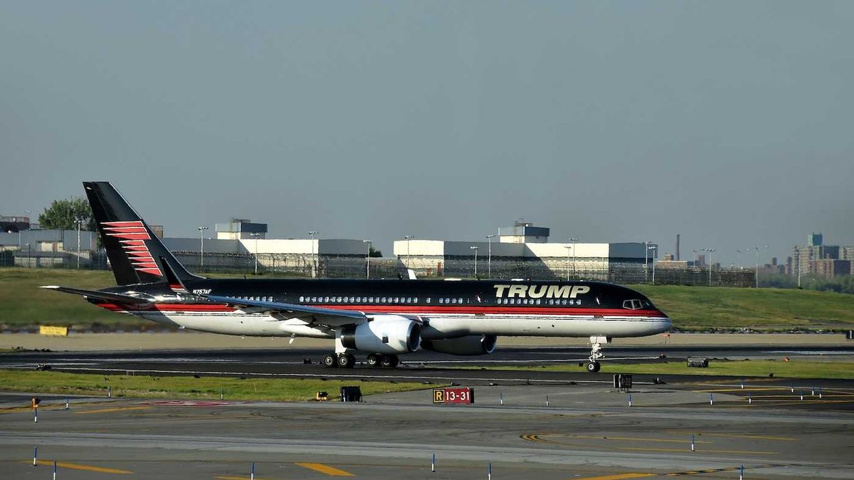 Boeing 757 jet airplane bearing the logo of Donald Trump takes off from Laguardia New York City