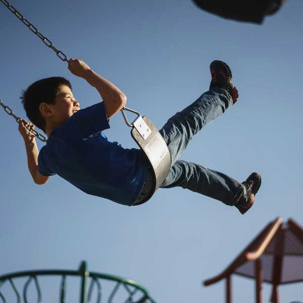 Boy on a swingset in a playground