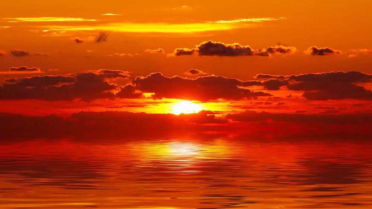 Bright red/orange sunset over water