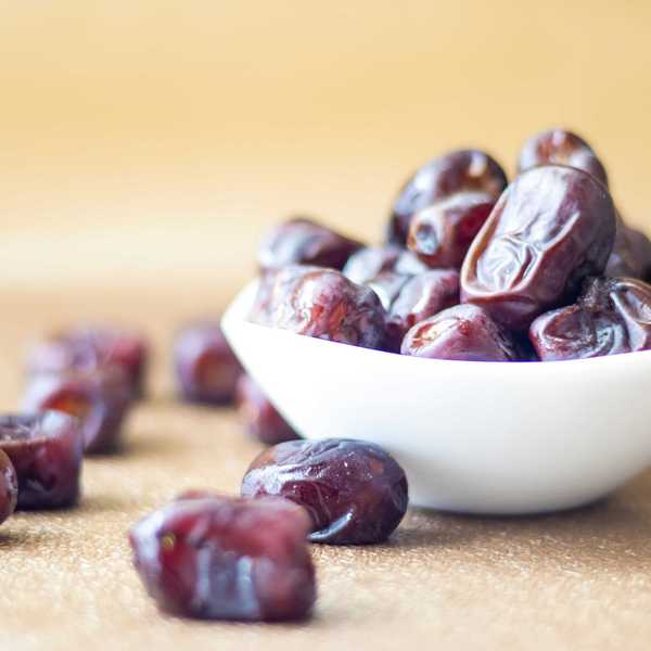 brown round fruit in white ceramic bowl