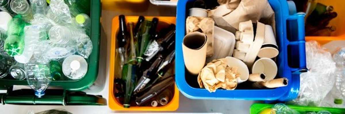 Buckets of recycling, including plastic bottles.