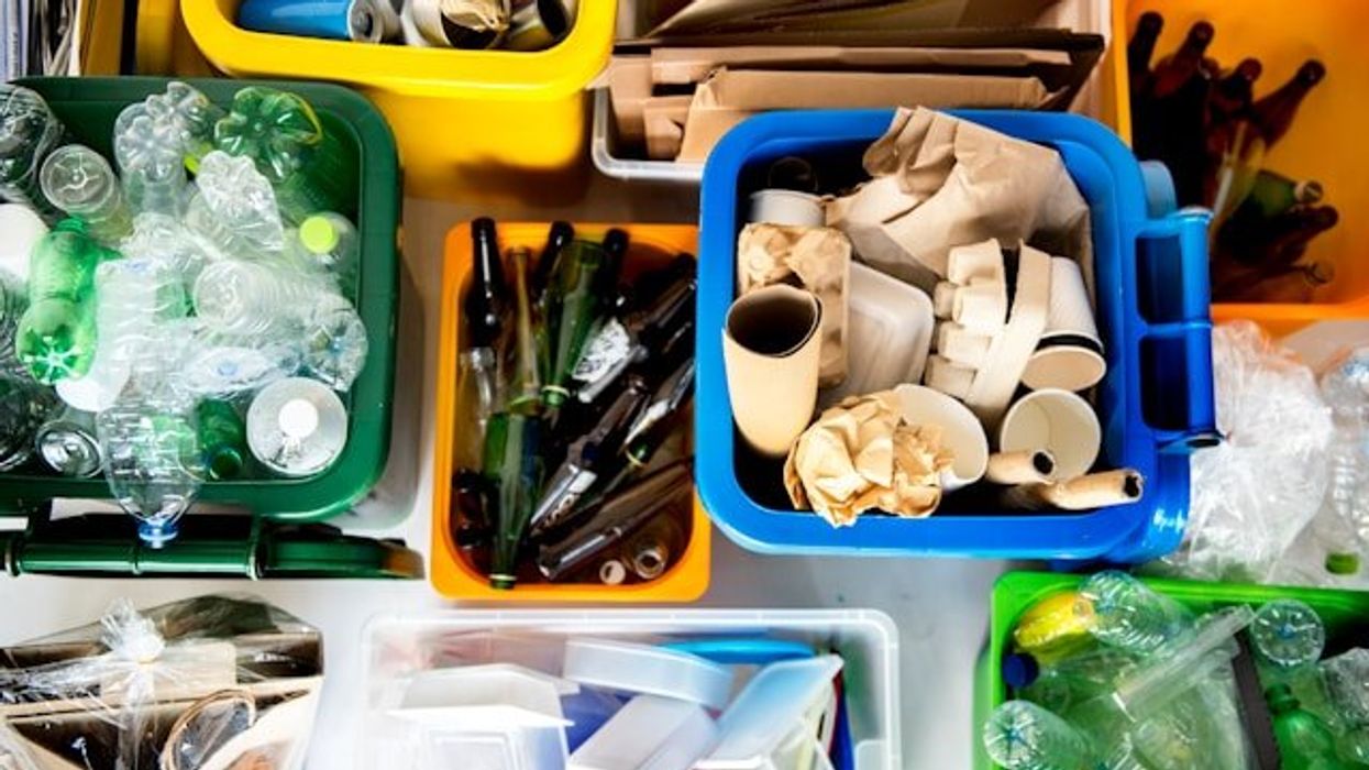 Buckets of recycling, including plastic bottles.