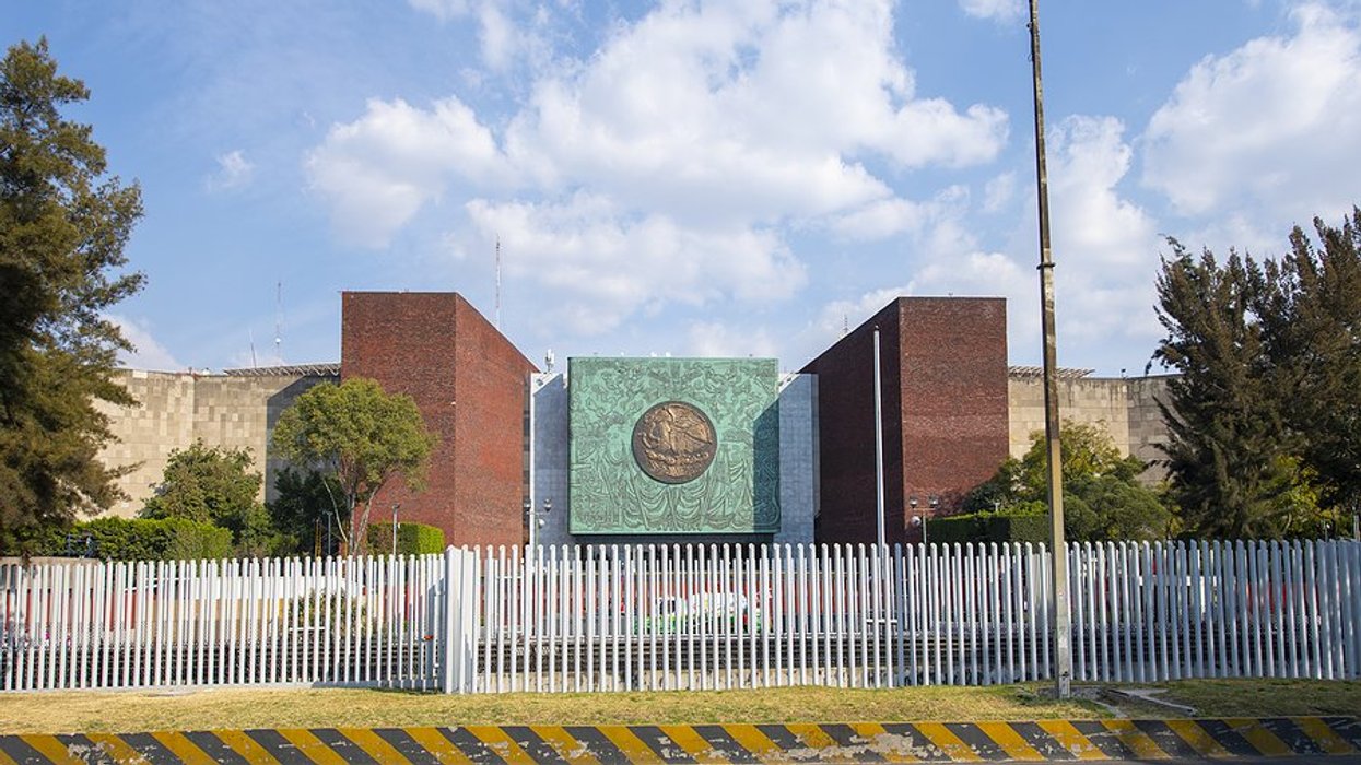 building in Mexico with white fence around it