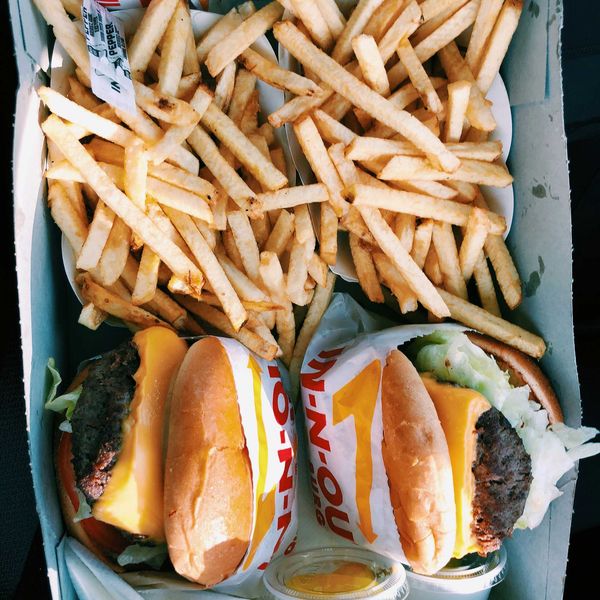 burgers and fries inside box.