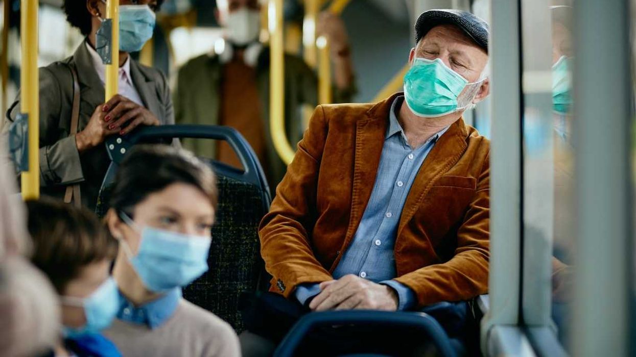 buss passengers wearing face masks