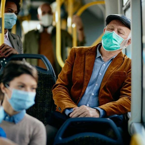 buss passengers wearing face masks