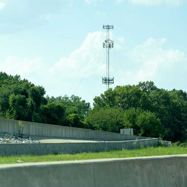 Cell tower rising above trees