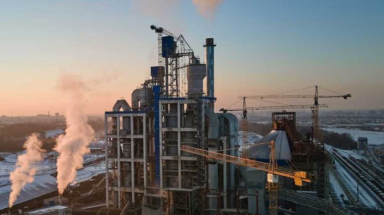 Cement plant flanked by three massive cranes