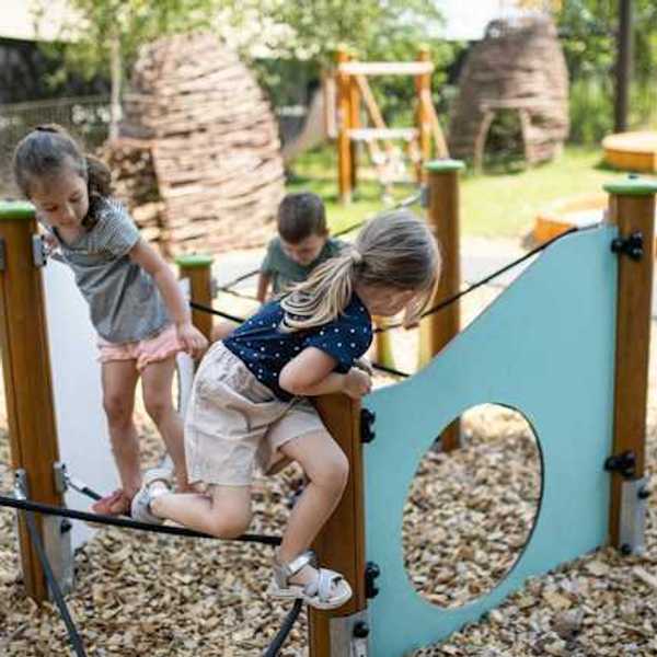 Children playing on play structures in a park