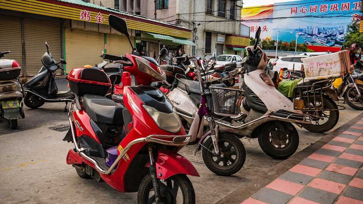 Chinese electric motorcycle parked in downtown district.