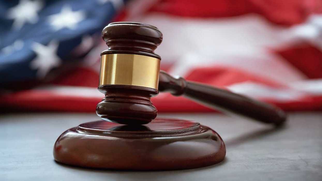 Close up of wooden judge gavel over the american flag