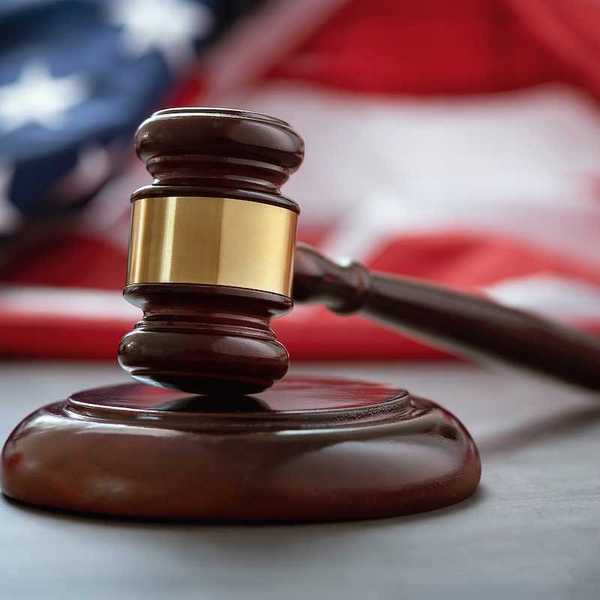 Close up of wooden judge gavel over the american flag